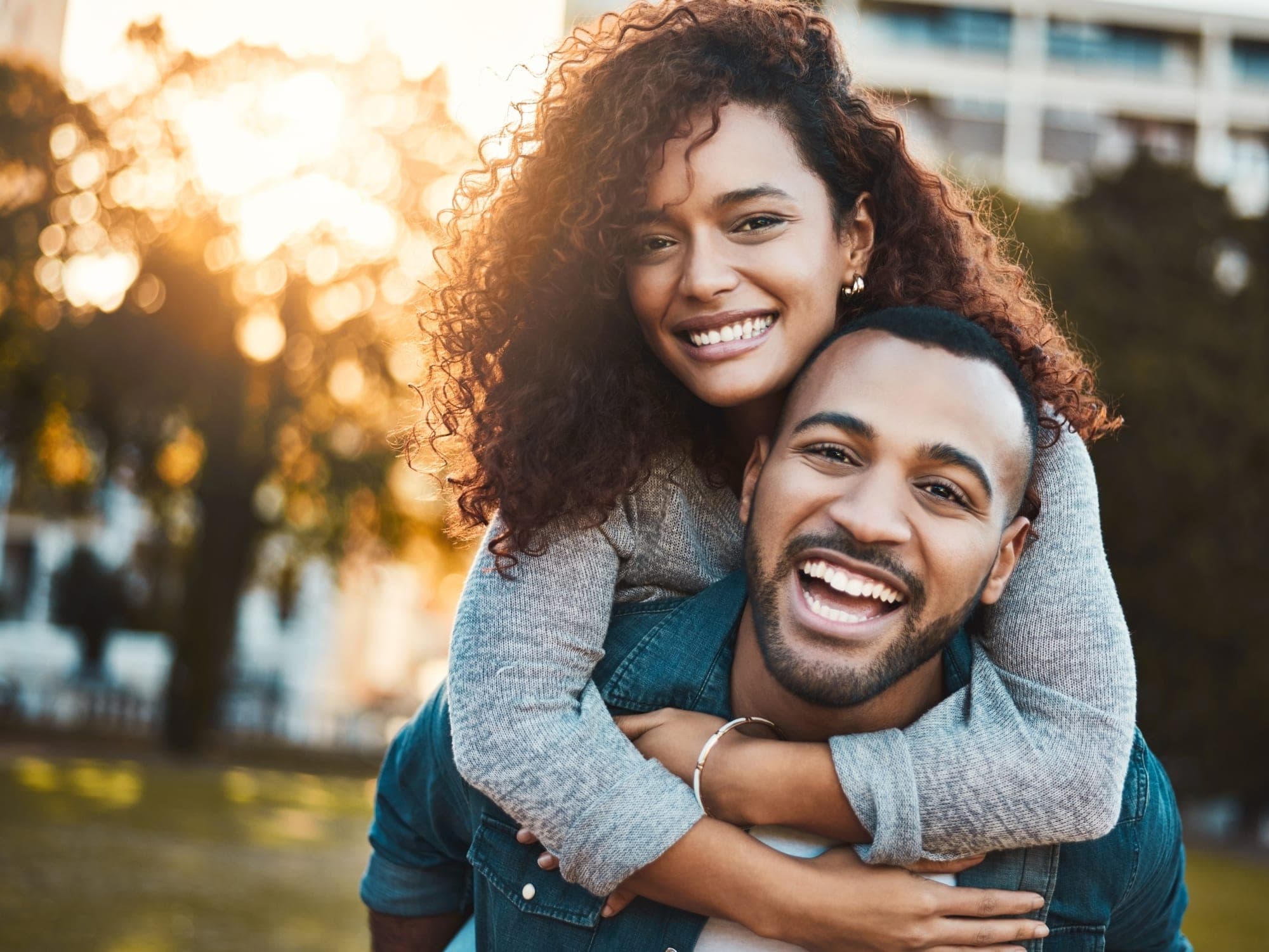 Happy couple smiling outdoors, new patients at London Square Dental Centre Calgary